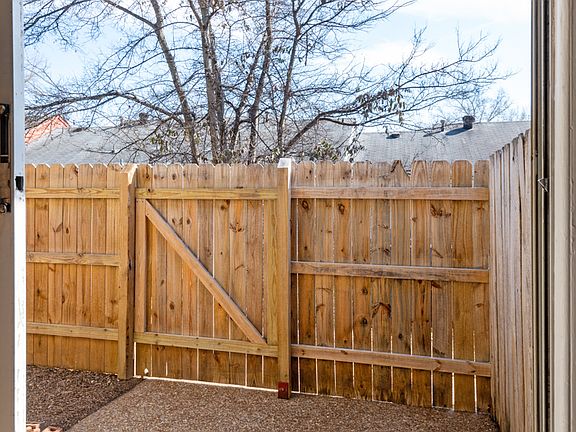 Fenced in back patio area with gate access to the back.