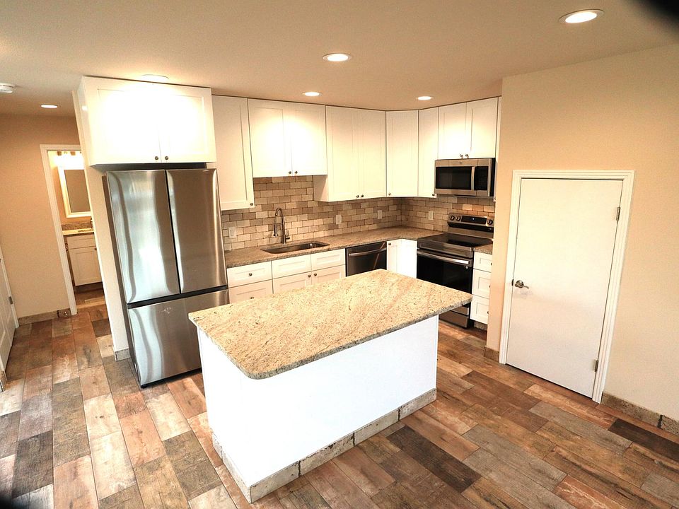 Kitchen, island staorage under stairs