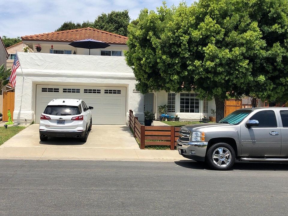 front of house with wood fence