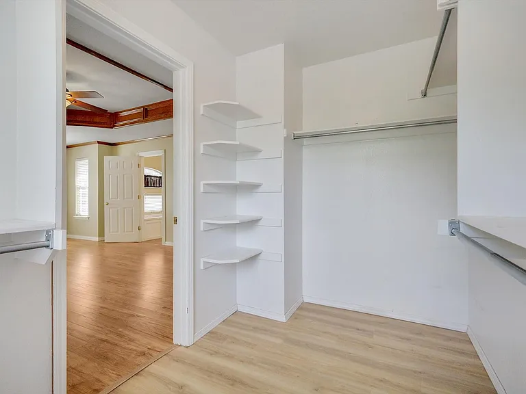 Primary closet features a window.