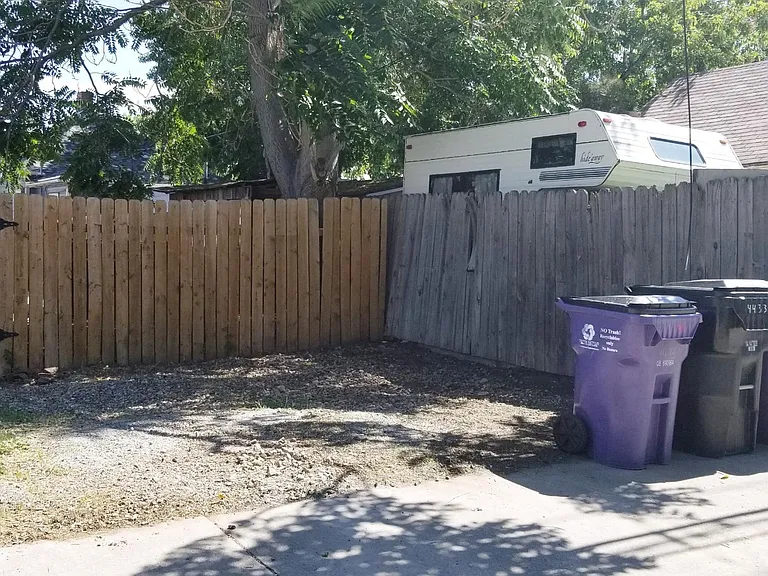 2 parking spaces off the back alley. 2 recycle bins and one trash. Once a month they take big items. Trash included.