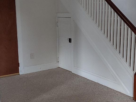Connecting area to front entry/living room and kitchen. Small closet with shelves under the steps. Also storage closet entrance.