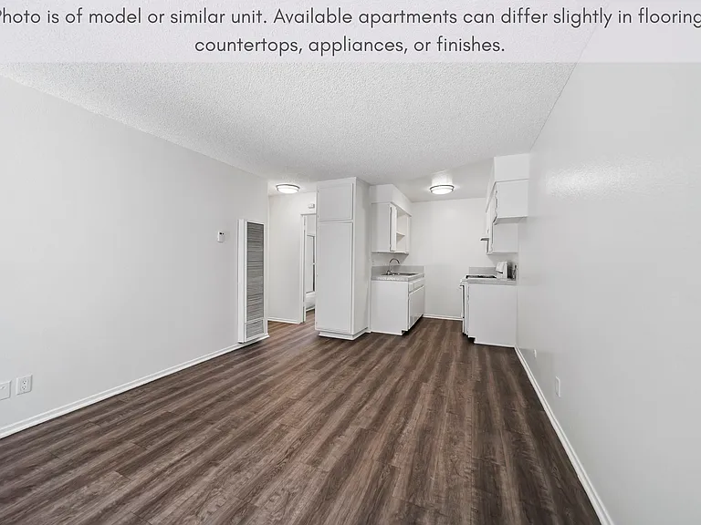 Open-concept living space featuring modern flooring and a seamless flow into the kitchen.