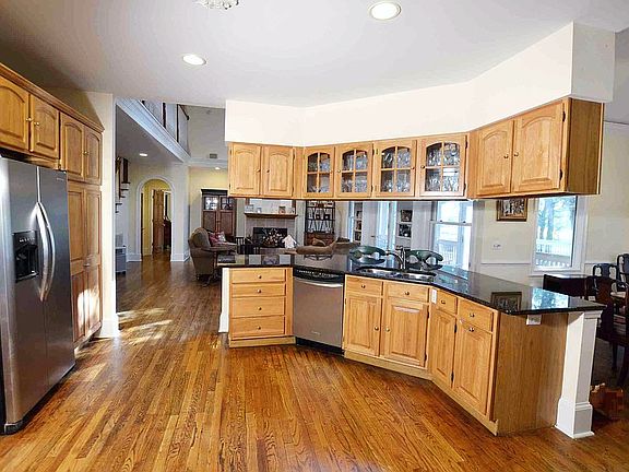 Kitchen has SS appliances and tumbled marble backsplash.
