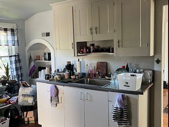 Large kitchen with built in for microwave. No disposal.