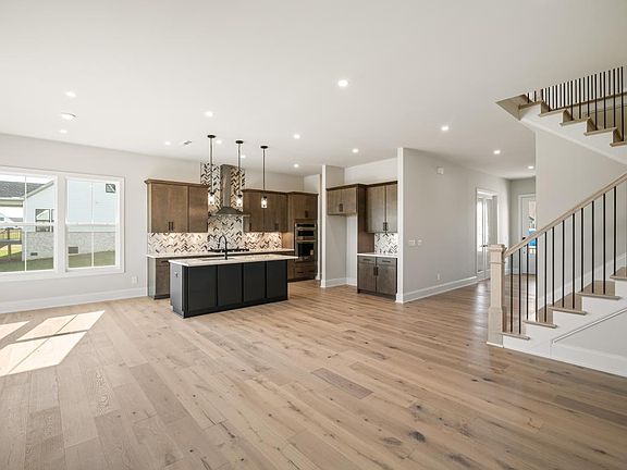Kitchen connectivity to great room with elegant contrasting fireplace surround