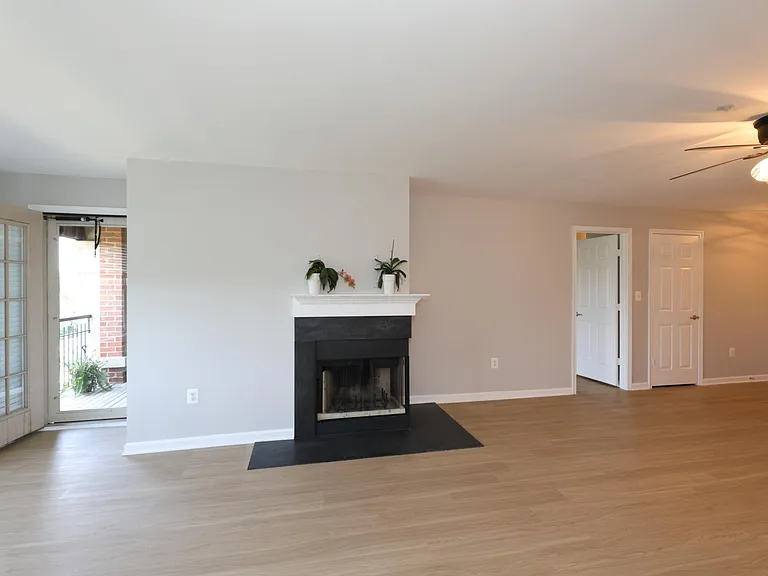 Living area view of balcony and master bedroom entries