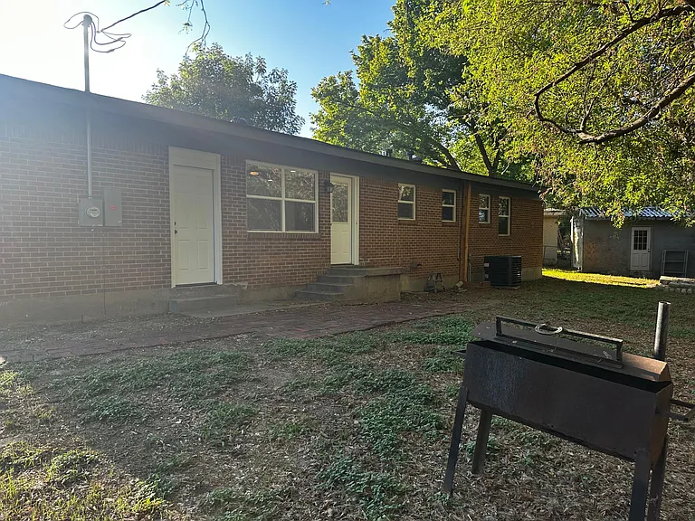 Large Backyard. Left door leads to garage. Right door leads to Kitchen/Dining area.