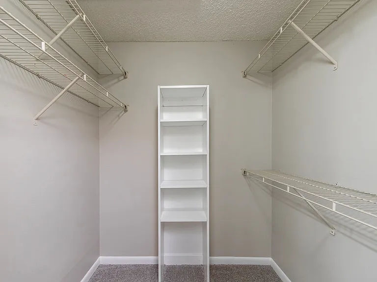 Relish spacious closets featuring custom shelving for the ultimate storage extravagance.