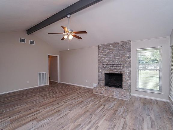 Adding character is the wood burning fireplace in the living area. Window blinds throughout the home.