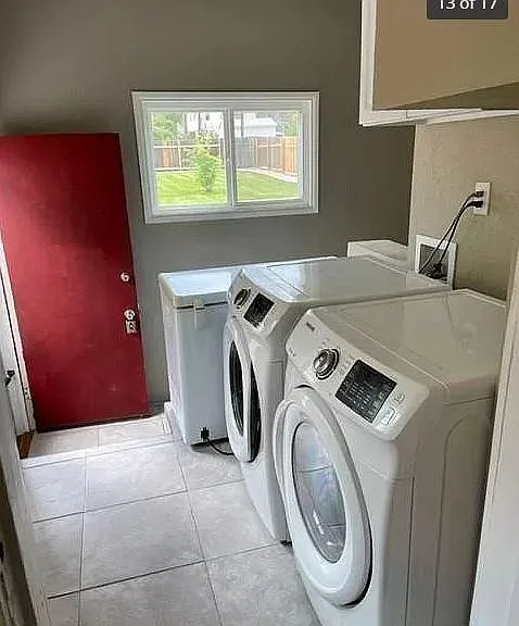 Utility room with washer, dryer, freezer and access to backyard