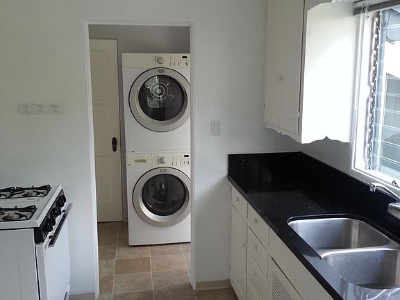 View of the kitchen and laundry room (washer/dryer and stove have since been replaced with new units).