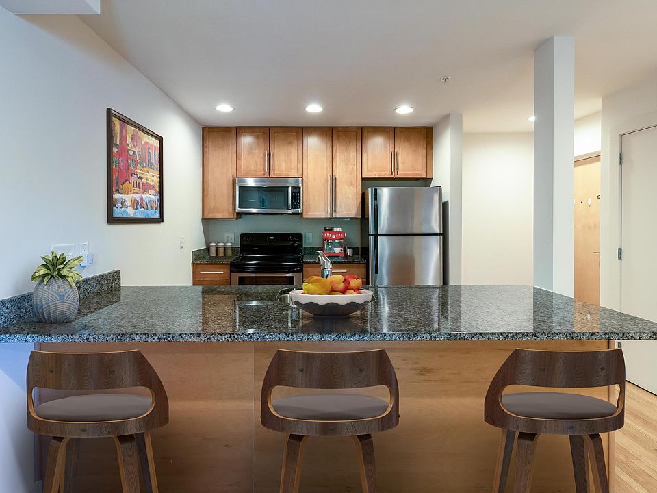 Open Kitchen with stainless steel appliances (digitally staged).
