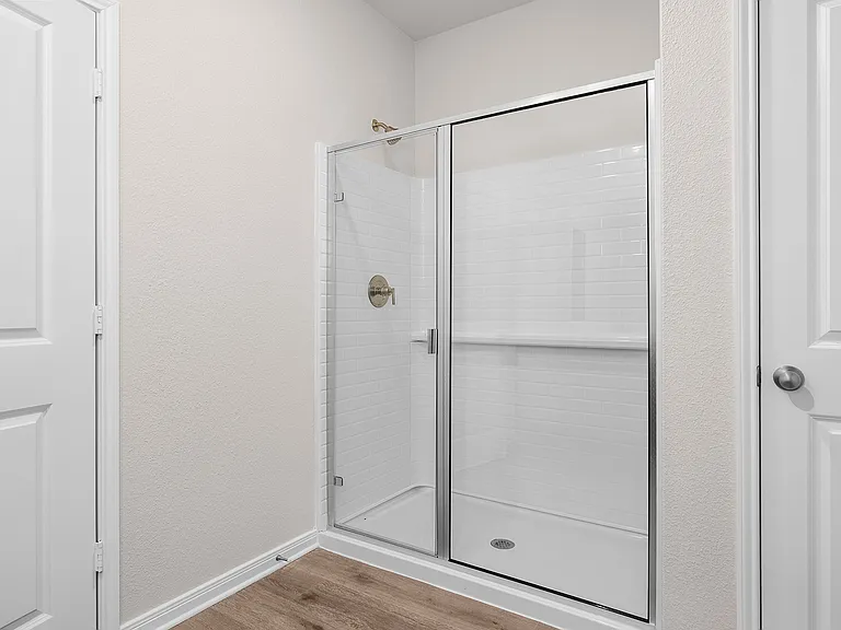 The master bathroom has a glass, walk-in shower.