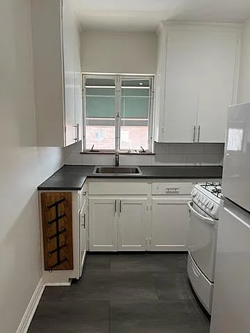 Ample kitchen cabinets and cute wine rack.
