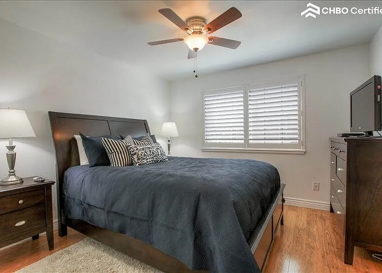 Master bedroom with fan and TV
