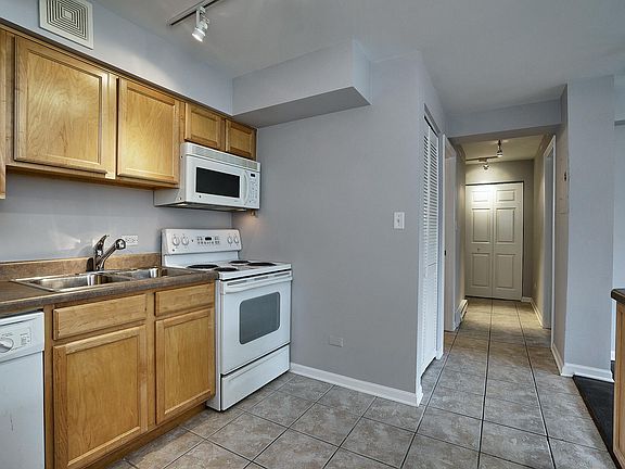Kitchen and view down hallway toward bedroom, closets and exit.