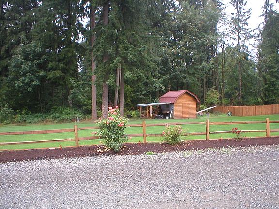 front yard, out building, split rail fence, flower bed
