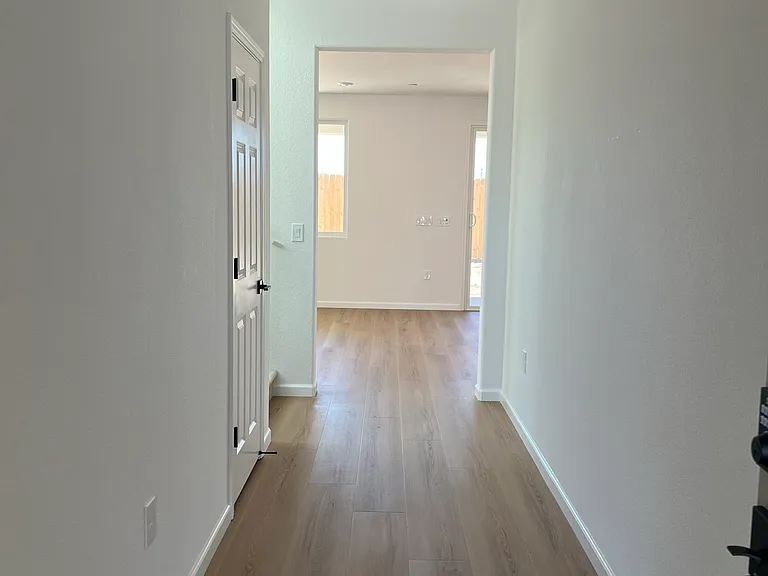 Entry Hall: Step inside to a bright, welcoming entry with wide-plank flooring that flows throughout the main level.