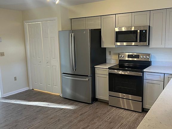 Kitchen with pantry & closet. Very nice track lighting.