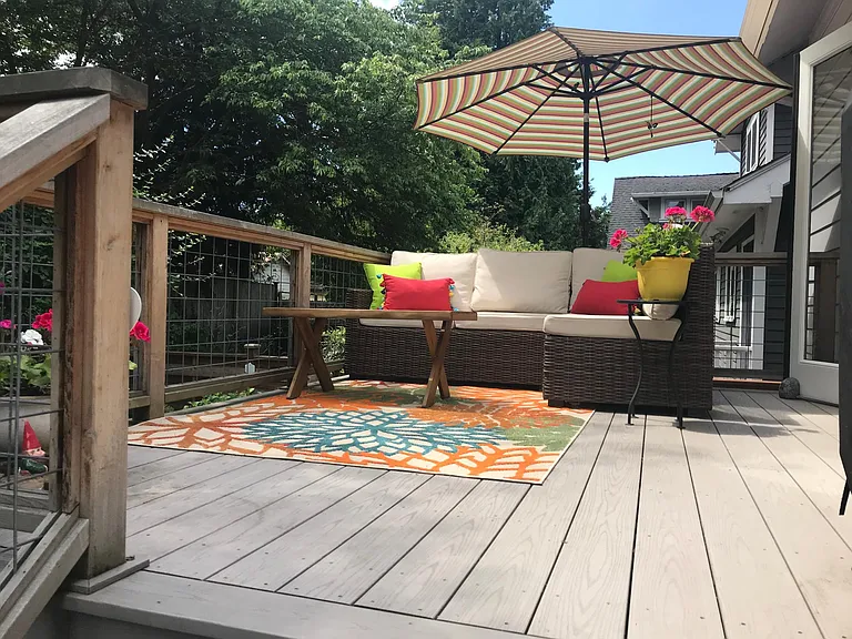 Double french doors open onto a sunny back deck