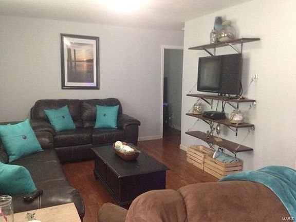 spacious living room/great room with built in shelves... freshly painted.