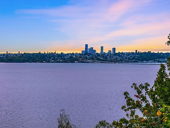 Unobstructed, protected westerly views of the City, Lake, Mountain and sunsets from nearly every square foot of this home.