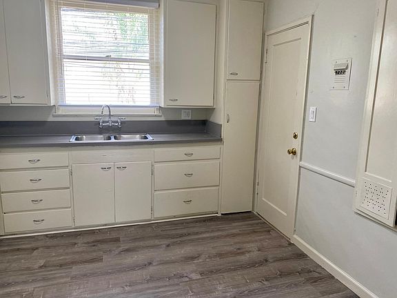 Kitchen with generous cabinetry and back entrance door