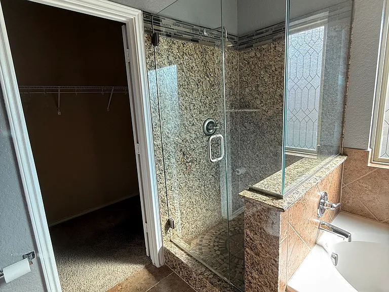 Enclosed glass walk in shower with decorative designer tile design