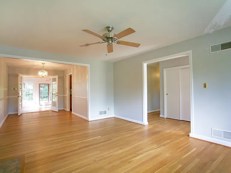 Living room flows to a beautiful dining room and on to a spacious sun room