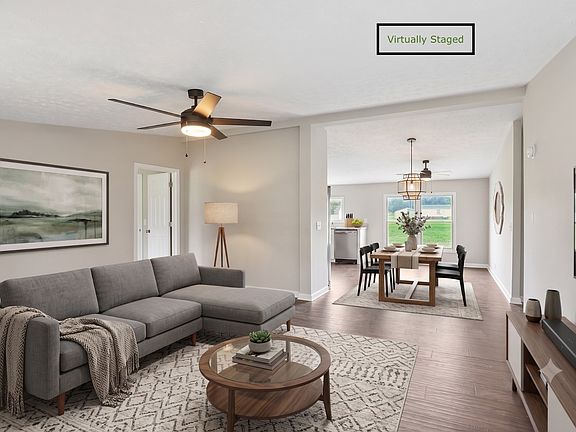 Spacious open-concept living and dining with new flooring and natural light throughout. Virtually staged.