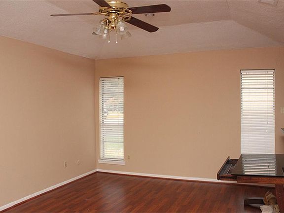 From foyer off to the left is this great living room with wet bar tucked away. Great wood flooring i