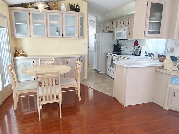 Main area comes furnished with dining table, built in buffet cabinets, sofa and big screen TV.