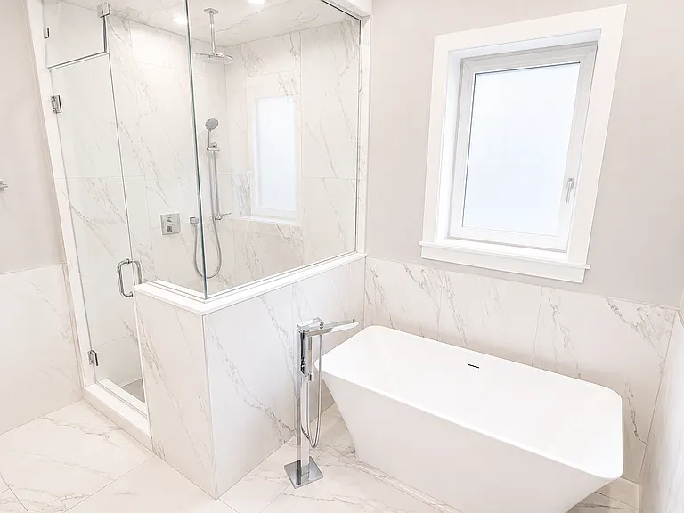Primary Bathroom with double vanity, heated floors, custom shower and full sized soaking tub.