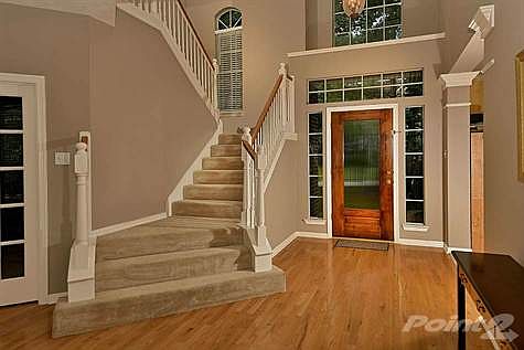High ceilings and wood floors welcome you in the entry.