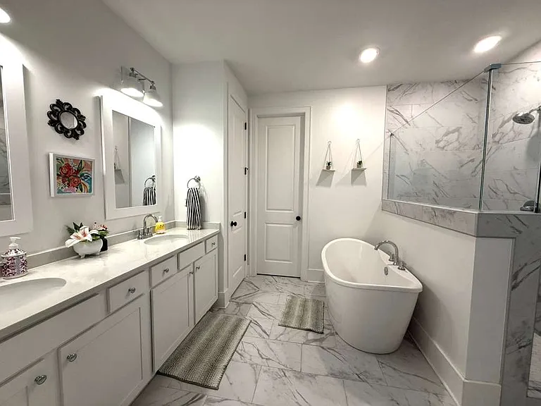 Master restroom with tub and standing shower