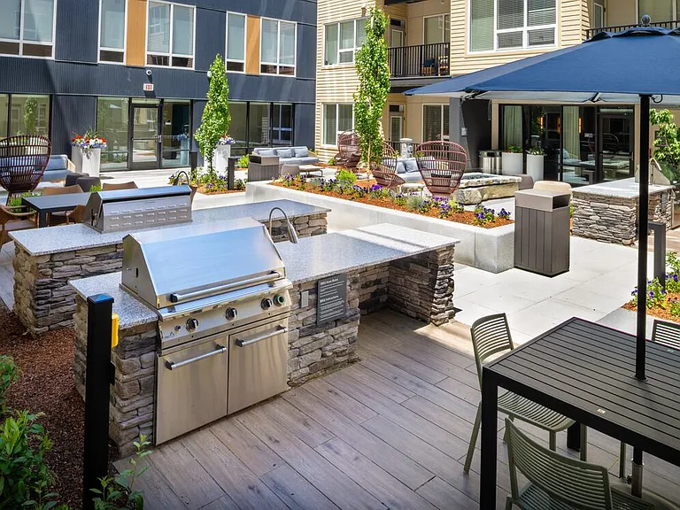 Courtyard #2 gathering space with lounge seating and bbq grills