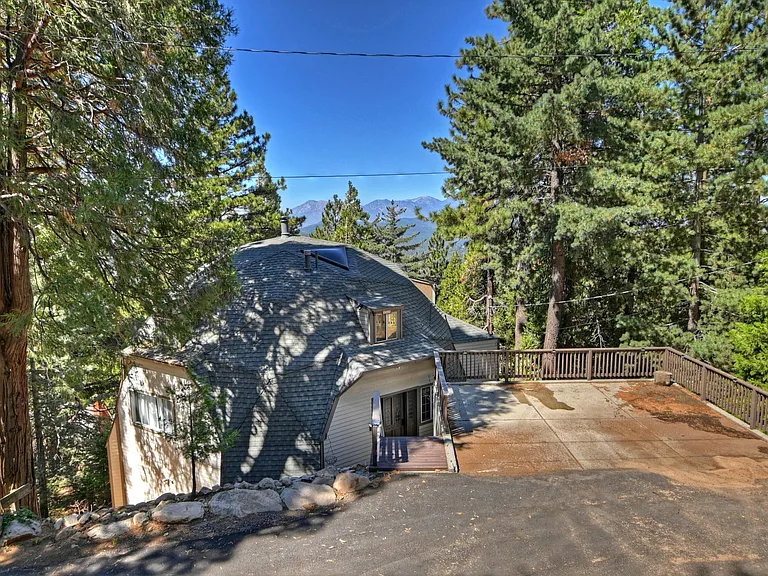 Front view of the home and parking pad that fits 2 cars