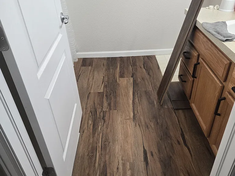 Full private bathroom with new hardwood floors and light fixtures