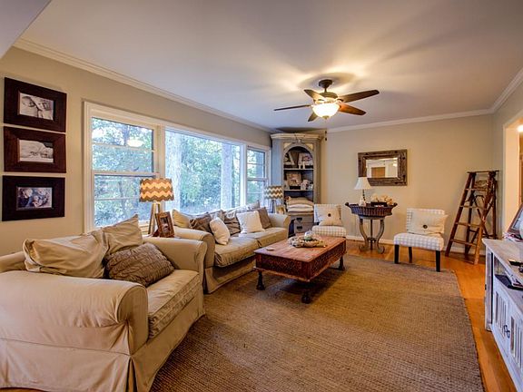 Large living room with picture window overlooks backyard
