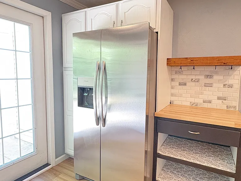 A built-in coffee/tea bar beside the brand new refrigerator adds both convenience and charm.
Hooks below the wood shelf to diplay your favorite mugs as well as lower cabinet space, and a drawer to store your coffee/tea essentials.