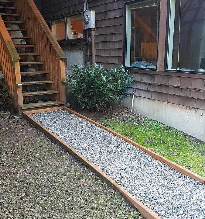 Gravel pathway leads to the apartment door,