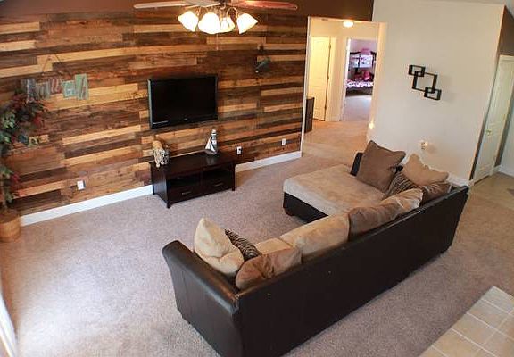 Living room with unique, wood slated wall