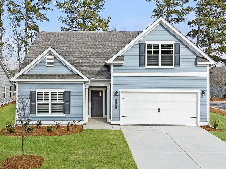 Stylish exterior of the two-story Wakefield with a private driveway and attached garage.