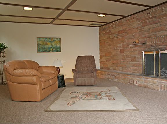 Family room with sandstone fireplace.