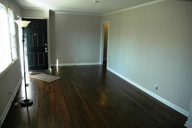 Large Living Room with newly refinished hardwoods.
