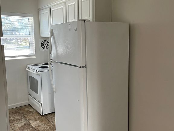 New stove and refridgerator. Tile flooring throughout the kitchen