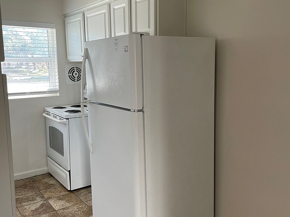 New stove and refridgerator. Tile flooring throughout the kitchen