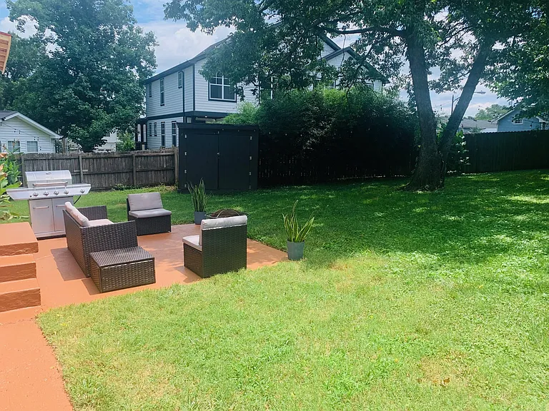 Fenced in backyard with patio