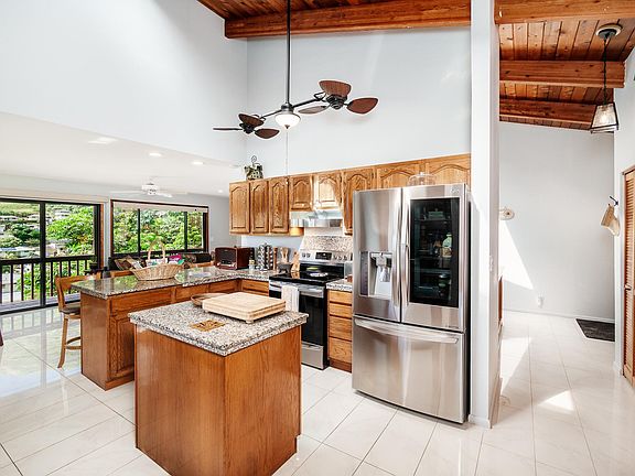 beautiful kitchen with high end appliances, vaulted ceiling, double ceiling fan, open floor plan, lots of pantry space